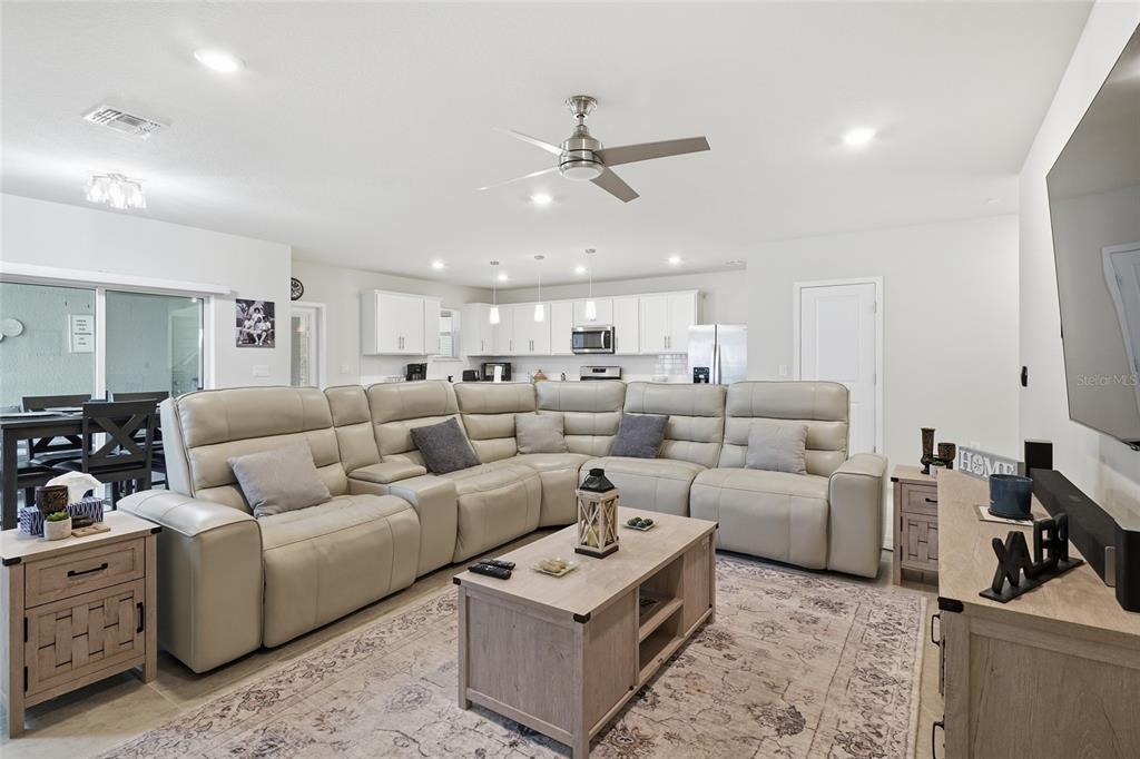 4071 Feather Tree Drive Apopka, FL 32712 - Photo 18 of 52 a living room with furniture a ceiling fan and a rug