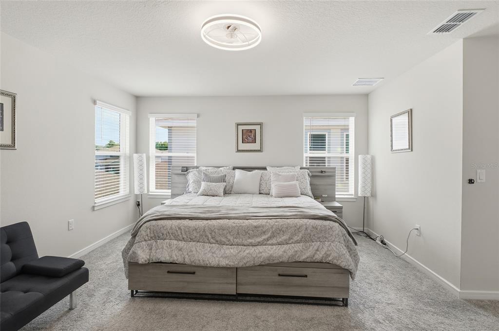 4071 Feather Tree Drive Apopka, FL 32712 - Photo 26 of 52 a bedroom with a bed and a couch