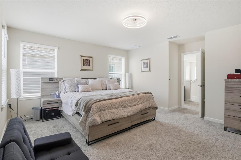 4071 Feather Tree Drive Apopka, FL 32712 - Photo 27 of 52 a spacious bedroom with a bed and a couch
