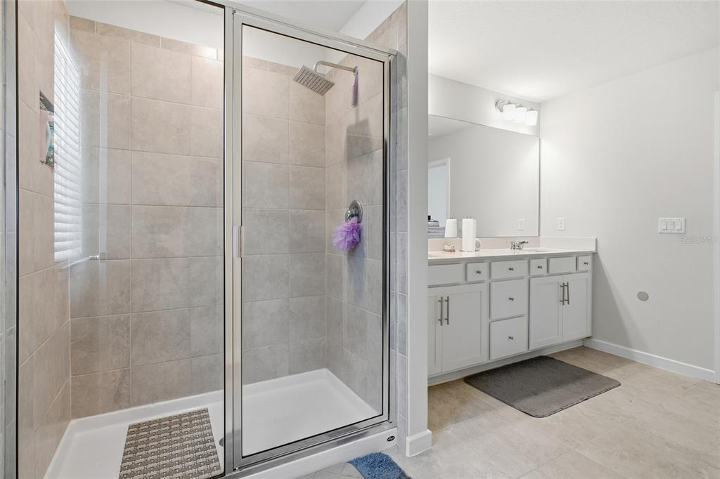 4071 Feather Tree Drive Apopka, FL 32712 - Photo 29 of 52 a bathroom with a shower sink and mirror