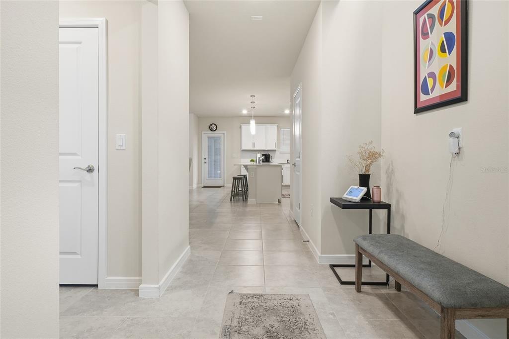 4071 Feather Tree Drive Apopka, FL 32712 - Photo 3 of 52 a hallway with painting on the wall and a potted plant