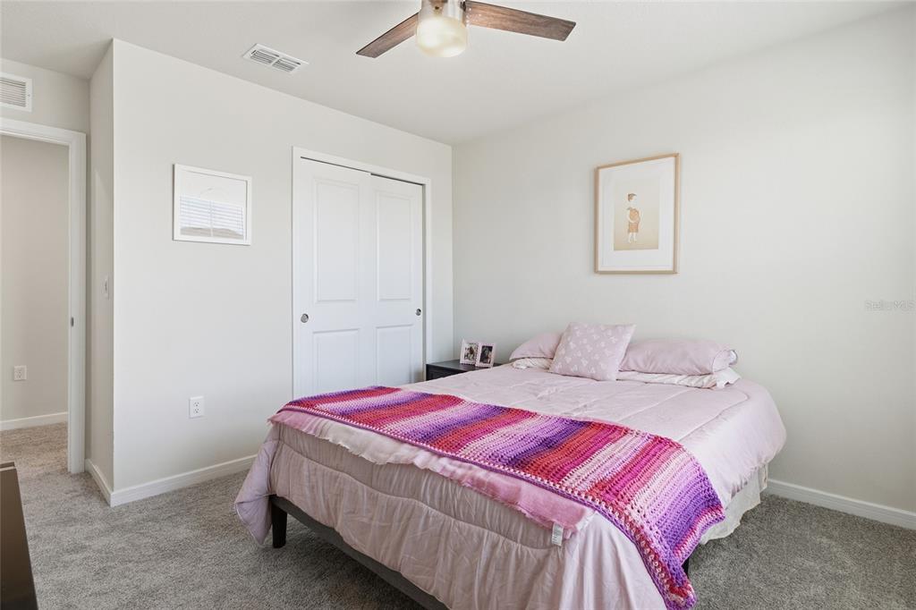 4071 Feather Tree Drive Apopka, FL 32712 - Photo 31 of 52 a bedroom with a bed and a chandelier