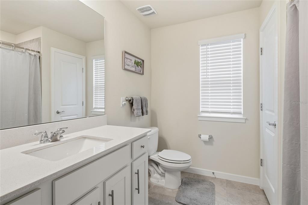 4071 Feather Tree Drive Apopka, FL 32712 - Photo 33 of 52 a bathroom with a sink toilet and a mirror