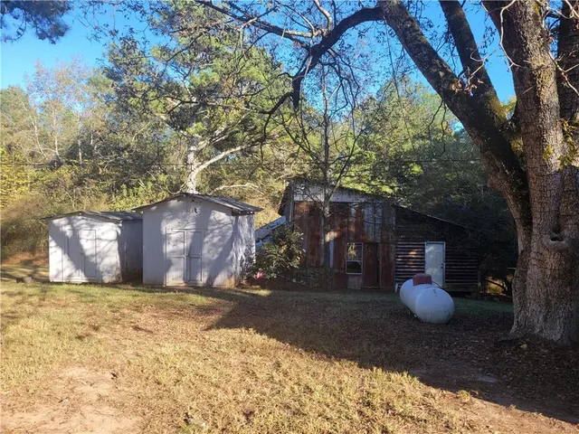 a view of large tree in front of house