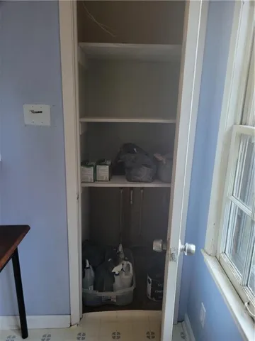 a room with a wooden floor and a window