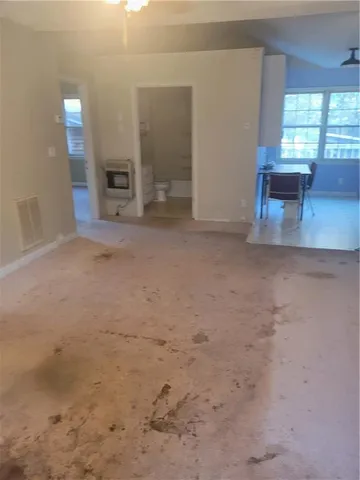 a view of empty room with a fireplace