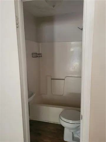 a bathroom with a toilet and a shower