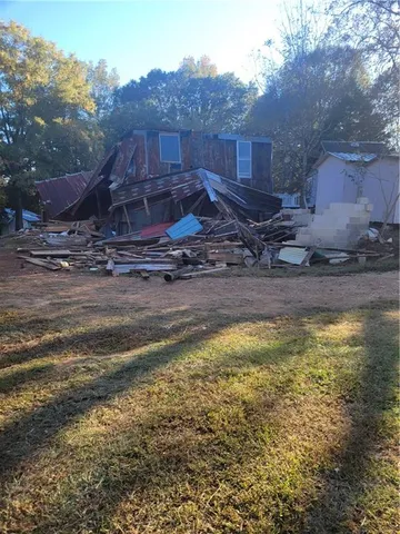 a view of a backyard with swimming pool