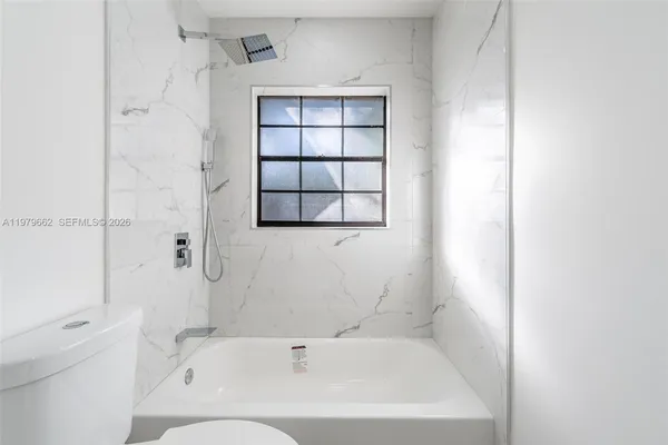 a bathroom with a bathtub and window