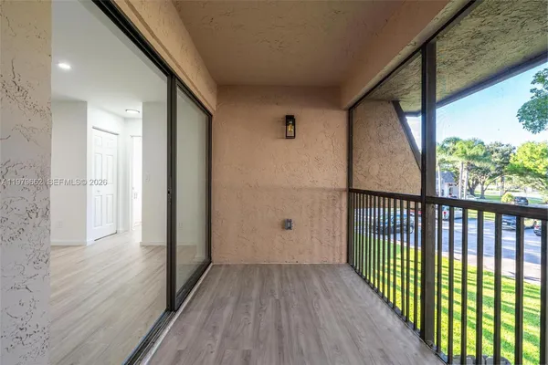 a view of a room with wooden floor and windows