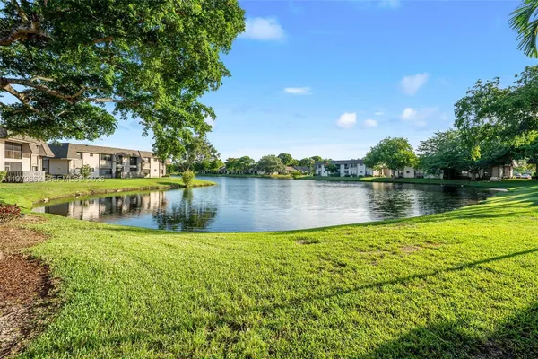 a view of a lake with houses in the background