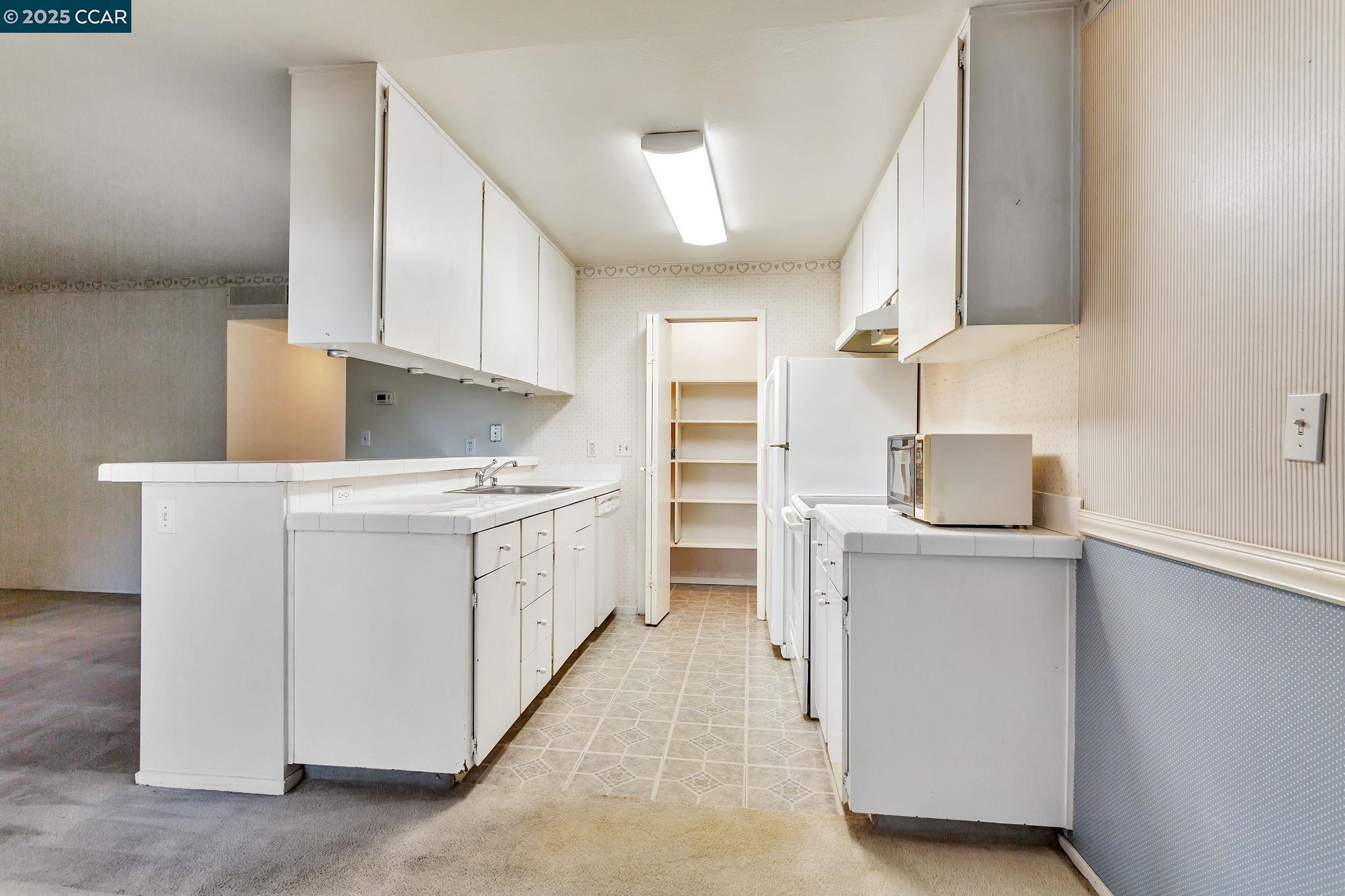 9085 Alcosta Boulevard, Unit 340 San Ramon, CA 94583 - Photo 8 of 25 a utility room with cabinets washer and dryer