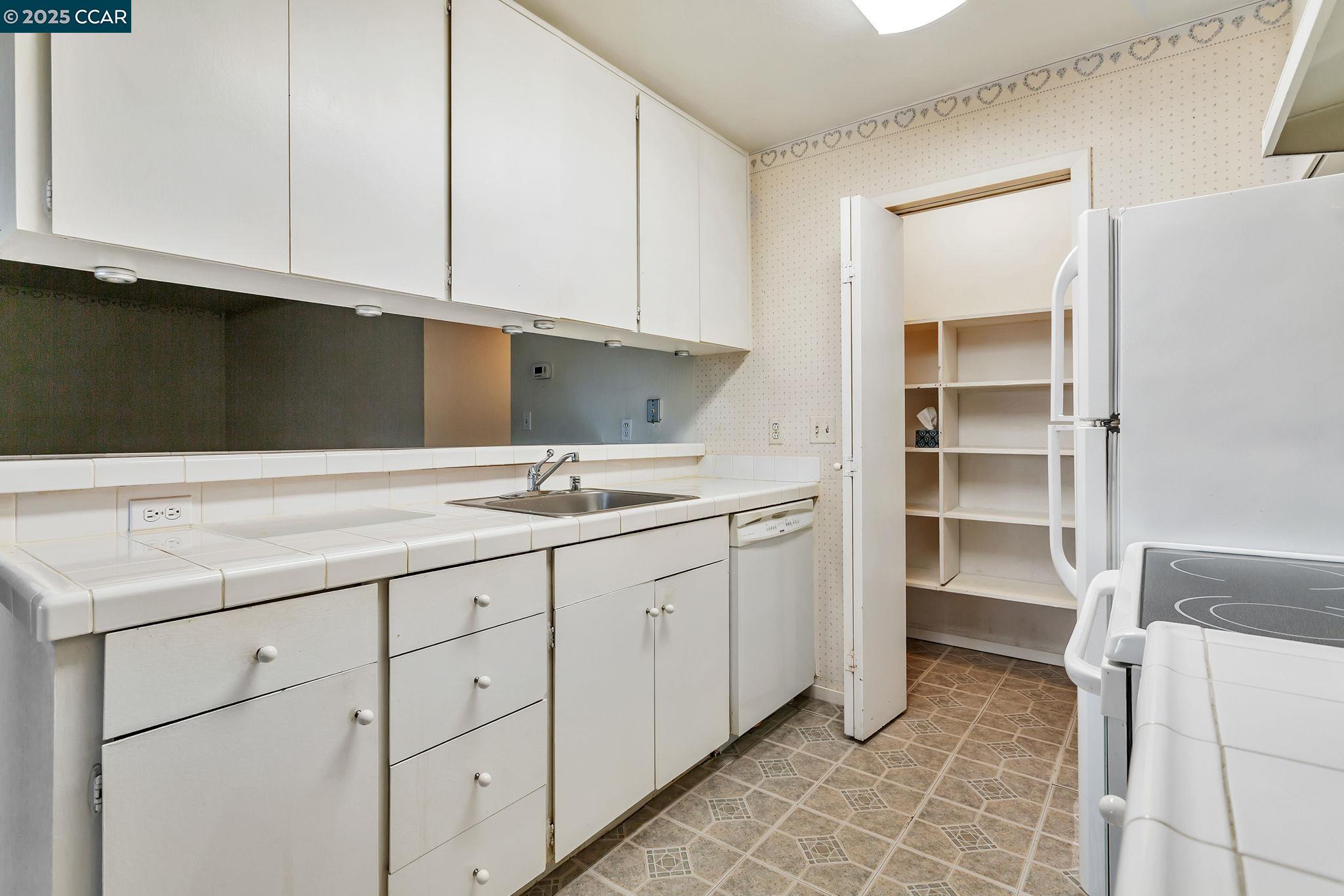 9085 Alcosta Boulevard, Unit 340 San Ramon, CA 94583 - Photo 10 of 25 a kitchen with a sink and cabinets