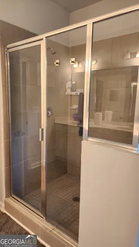 a bathroom with a glass shower door