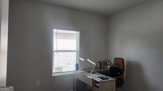 a workspace with furniture and window