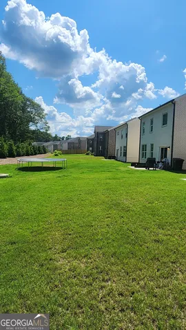 a view of a backyard of the house