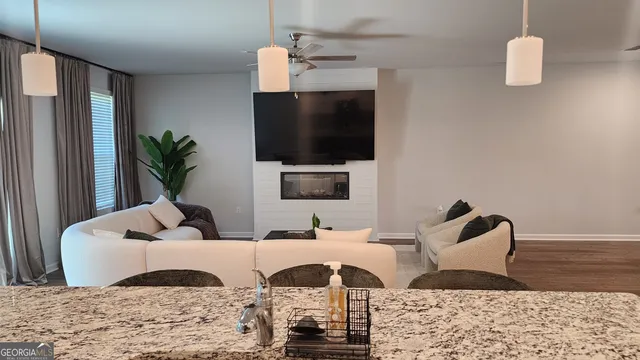 a living room with furniture and a flat screen tv