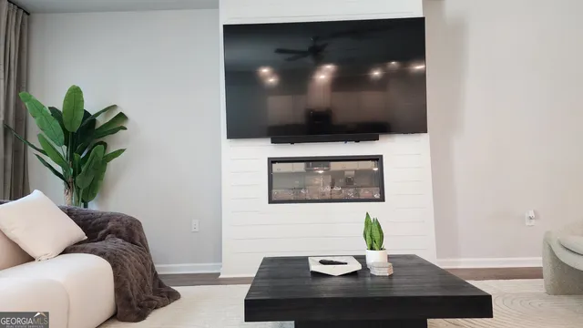 a living room with furniture and a potted plant