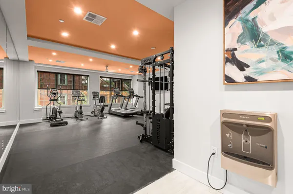 a room with gym equipment and a flat screen tv