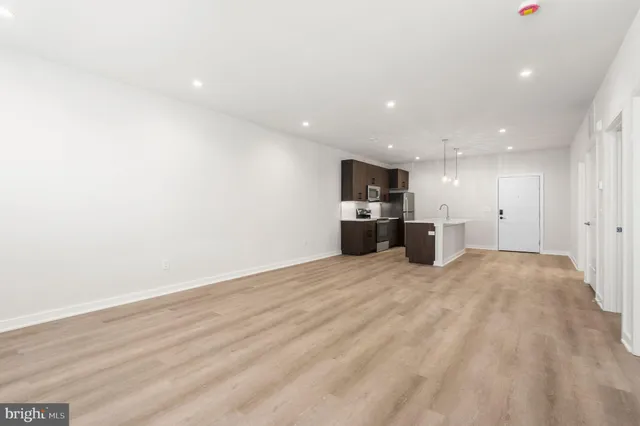 a view of kitchen with refrigerator and windows