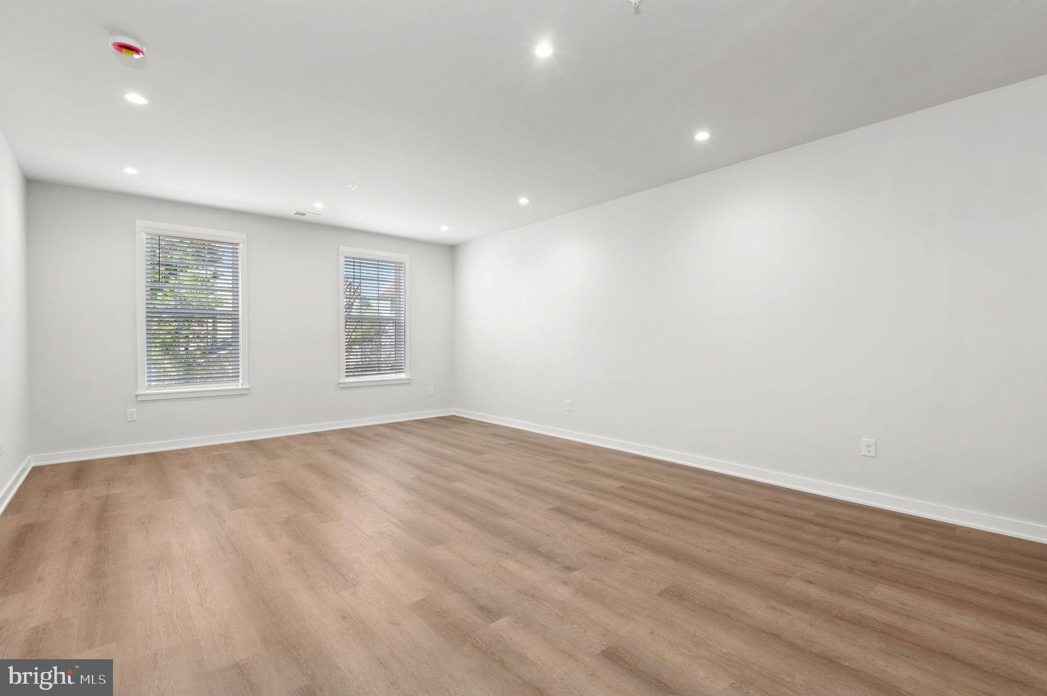 26 South York Road, Unit 204 Hatboro, PA 19040 - Photo 9 of 48 an empty room with wooden floor and windows