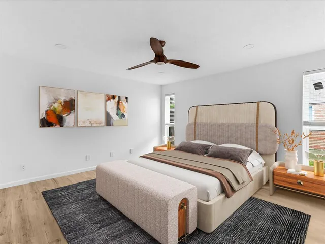 a bedroom with a bed and a painting on the wall