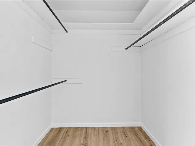 a open kitchen with white cabinets and stainless steel appliances