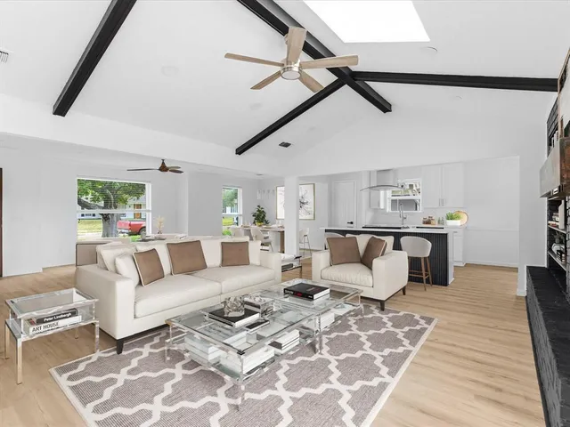 a living room with furniture and wooden floor