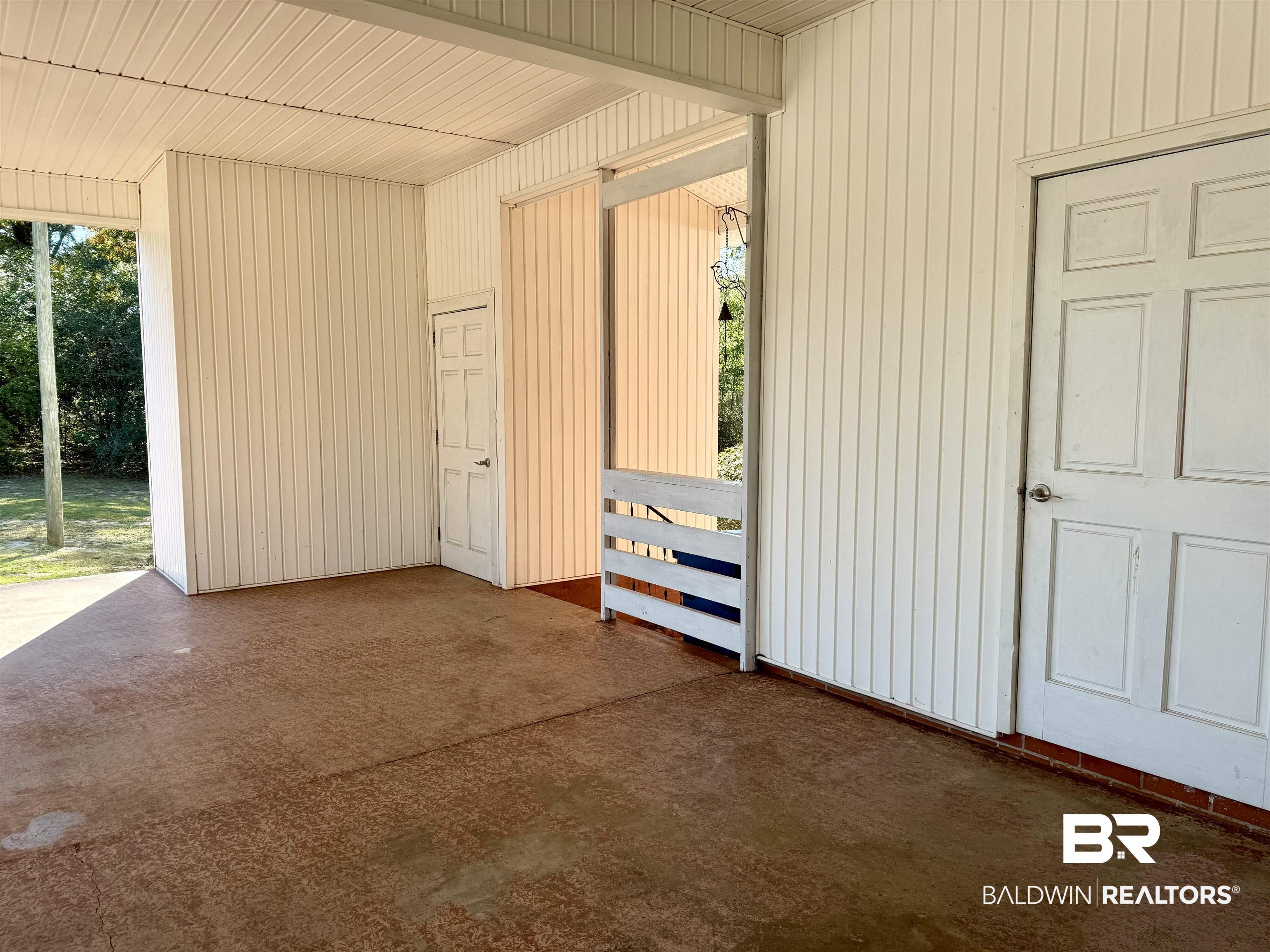 2785 Appleton Road Brewton, AL 36426 - Photo 24 of 28 Unfurnished bedroom with access to outside, wood walls, and concrete floors
