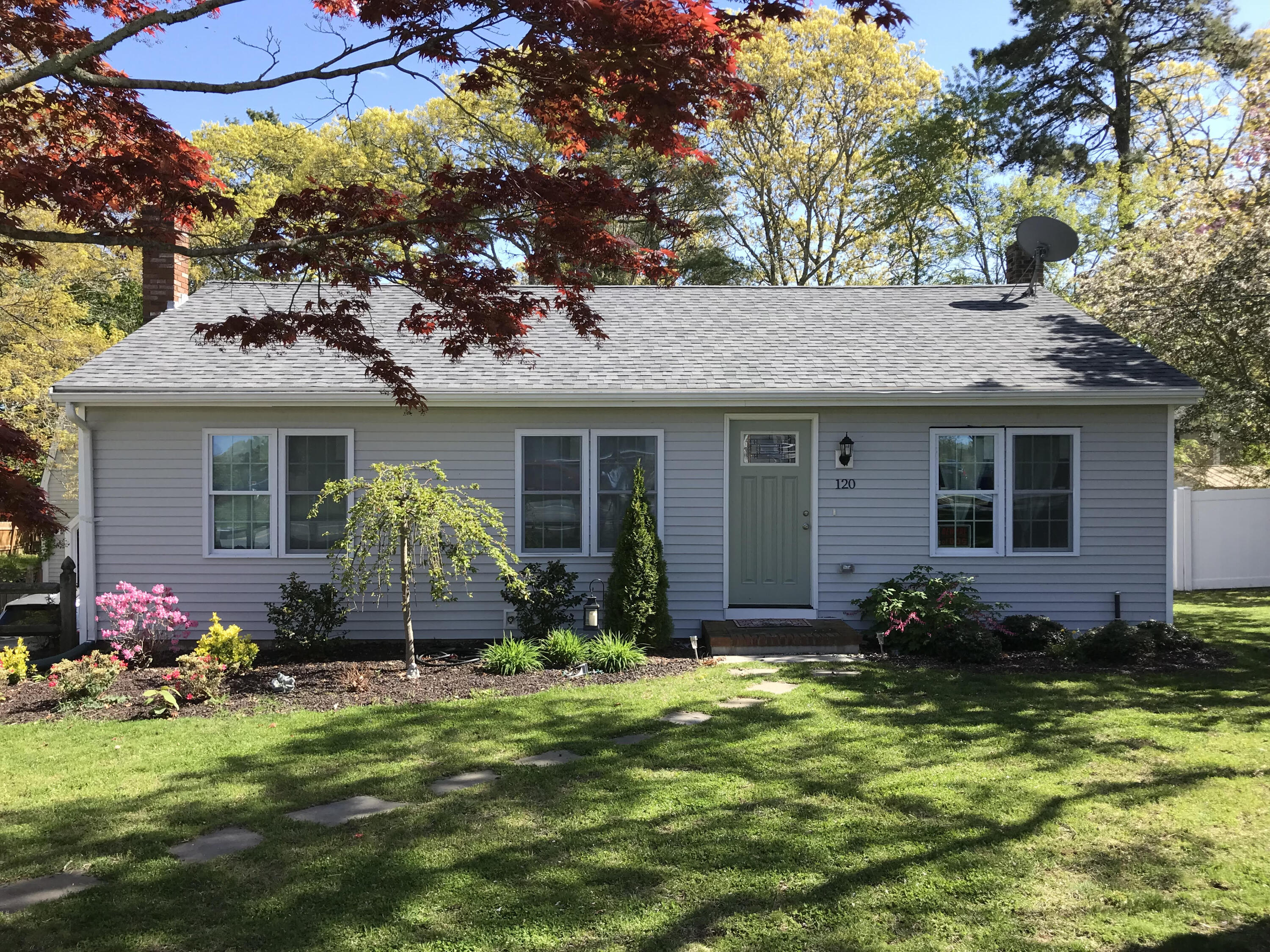 120 Puritan Road Buzzards Bay, MA 02532 - Photo 1 of 28 a front view of house with yard and green space