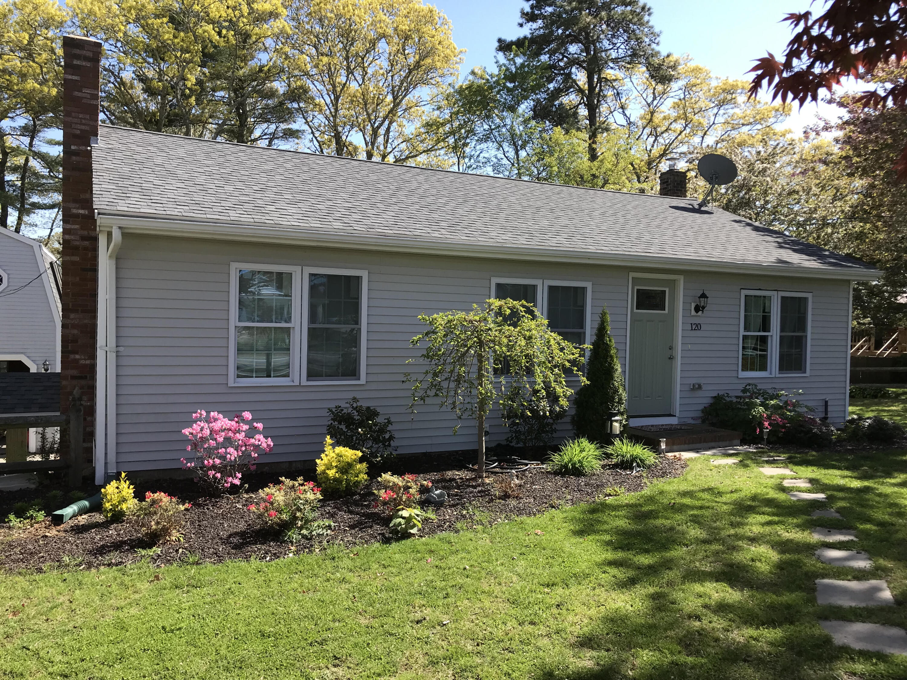 120 Puritan Road Buzzards Bay, MA 02532 - Photo 2 of 28 a front view of a house with a yard and outdoor seating
