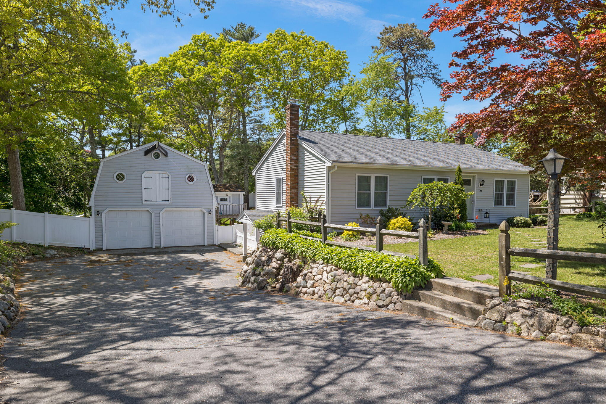 120 Puritan Road Buzzards Bay, MA 02532 - Photo 27 of 28 a backyard of a house with wooden fence and large tree