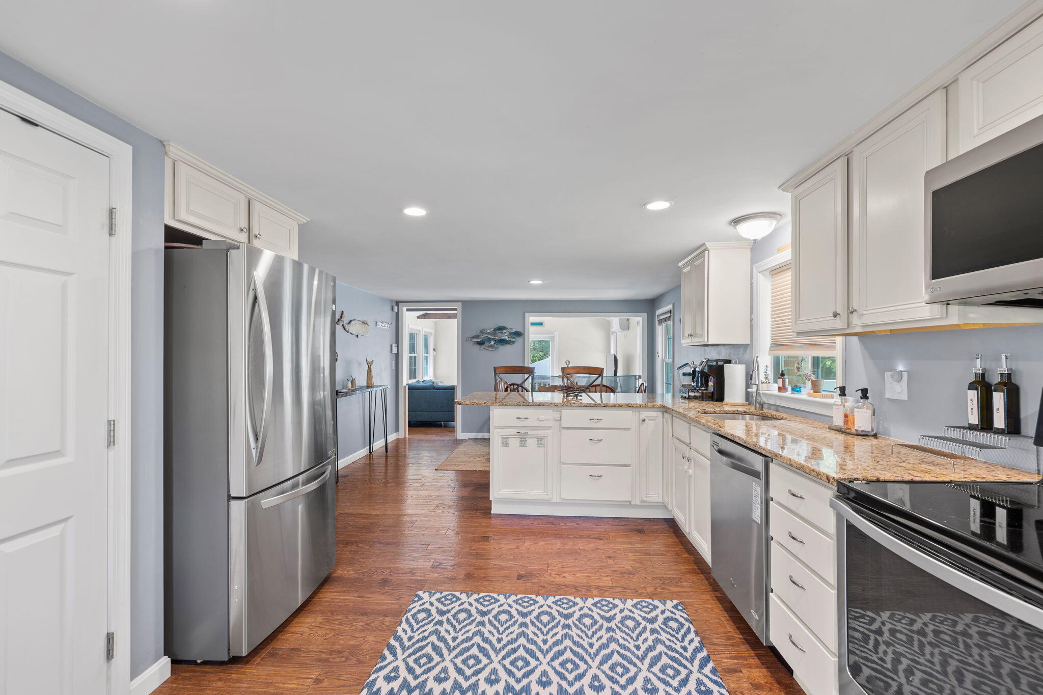 120 Puritan Road Buzzards Bay, MA 02532 - Photo 8 of 28 a kitchen with stainless steel appliances a refrigerator sink and microwave