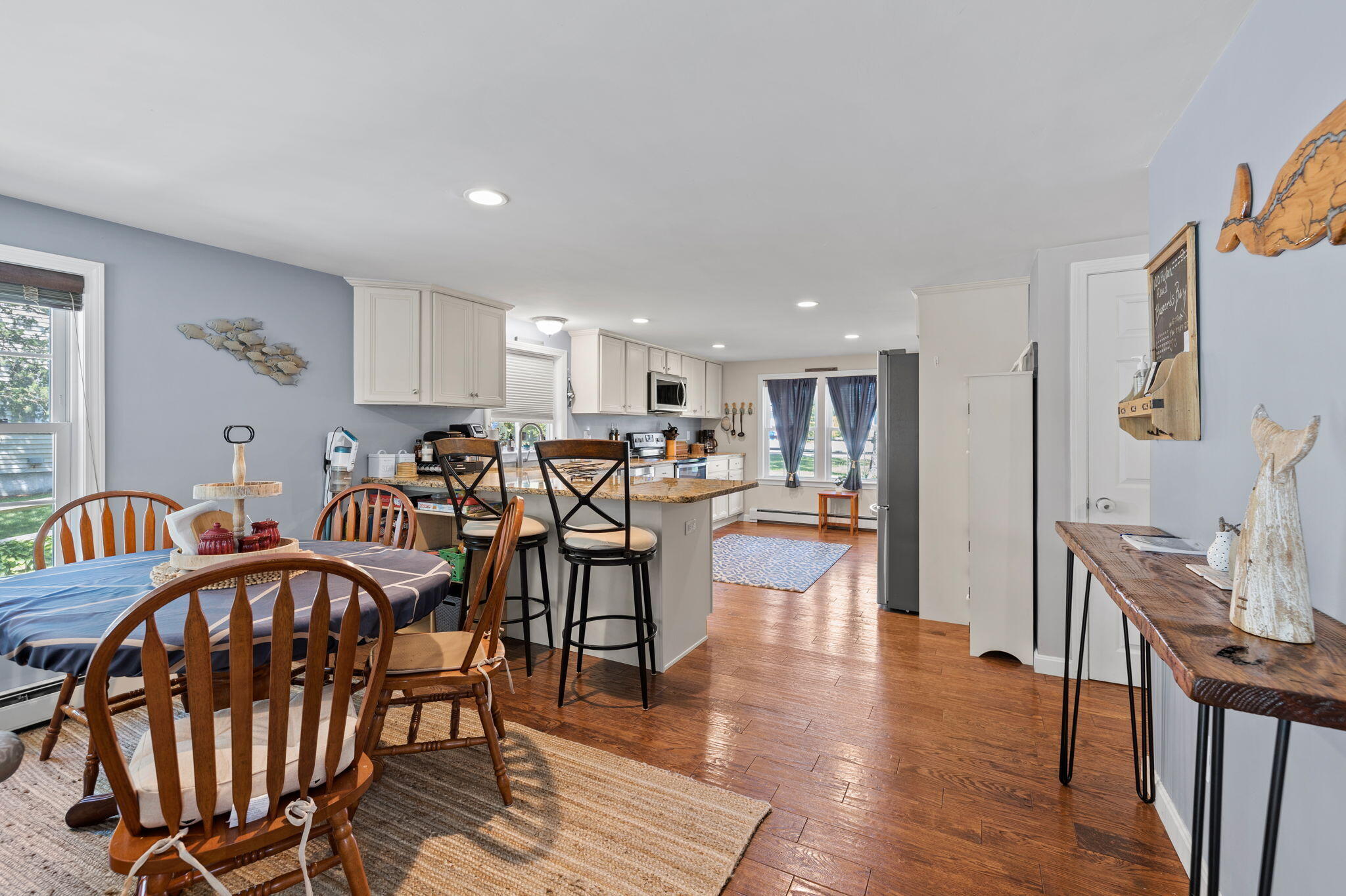 120 Puritan Road Buzzards Bay, MA 02532 - Photo 9 of 28 a view of a dining room kitchen with furniture and wooden floor