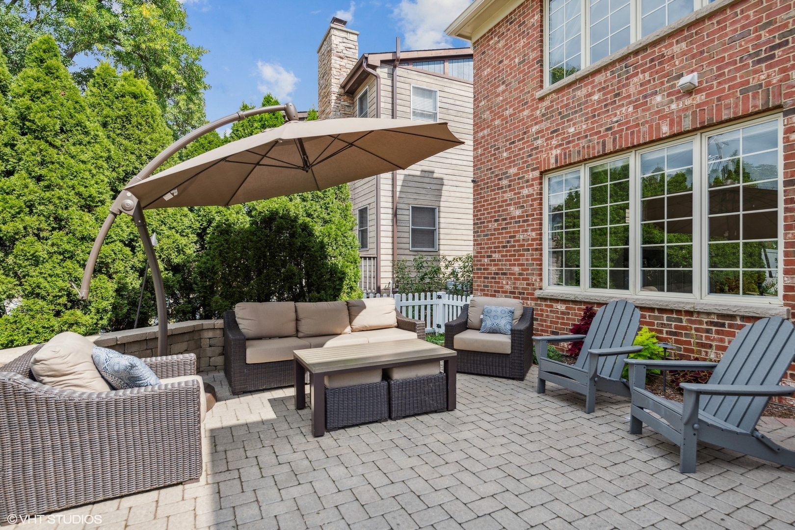254 Ridgeland Avenue Elmhurst, IL 60126 - Photo 31 of 37 a patio with patio a table and chairs under an umbrella