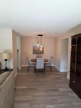 a dining room with furniture and wooden floor