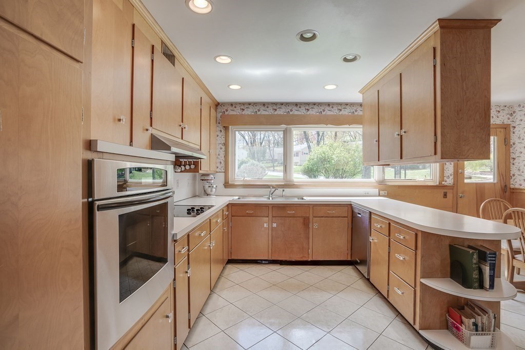 18 Apache Trail Arlington, MA 02474 - Photo 11 of 30 a kitchen with stainless steel appliances granite countertop a stove a sink and a microwave