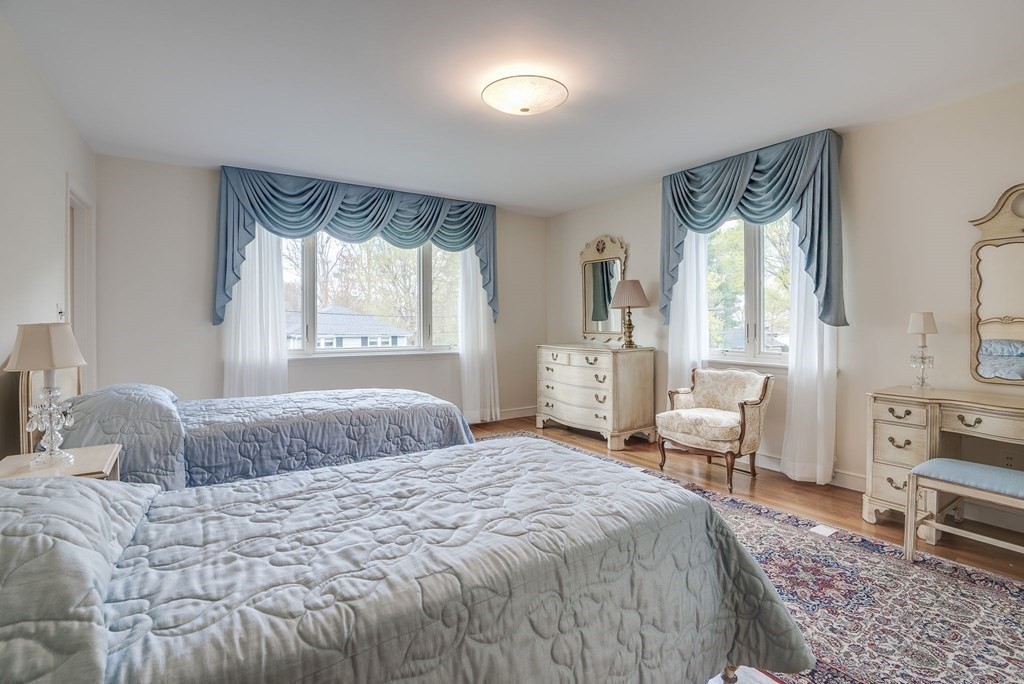 18 Apache Trail Arlington, MA 02474 - Photo 18 of 30 a bedroom with a bed and a large window