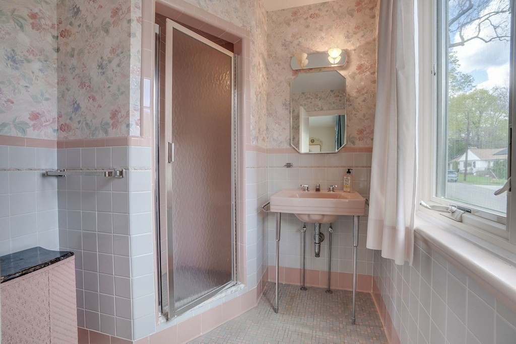 18 Apache Trail Arlington, MA 02474 - Photo 19 of 30 a bathroom with a sink a mirror and a shower