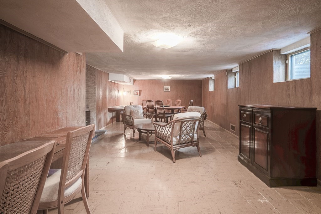 18 Apache Trail Arlington, MA 02474 - Photo 23 of 30 a living room with furniture and a dining table with projector the kitchen