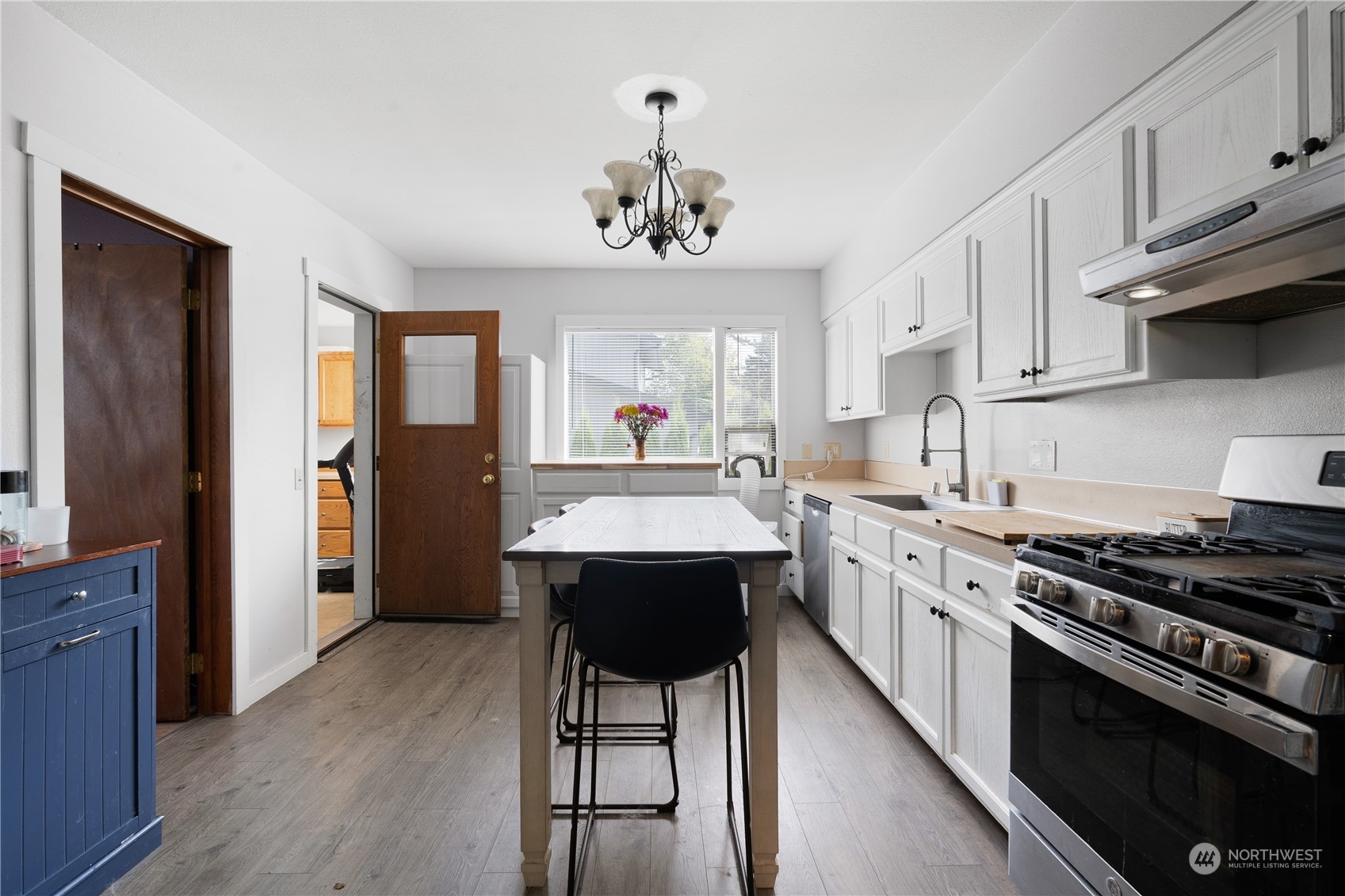 406 Cleveland Sumas, WA 98295 - Photo 12 of 33 a kitchen with stainless steel appliances a stove a sink dishwasher a refrigerator and white cabinets with wooden floor