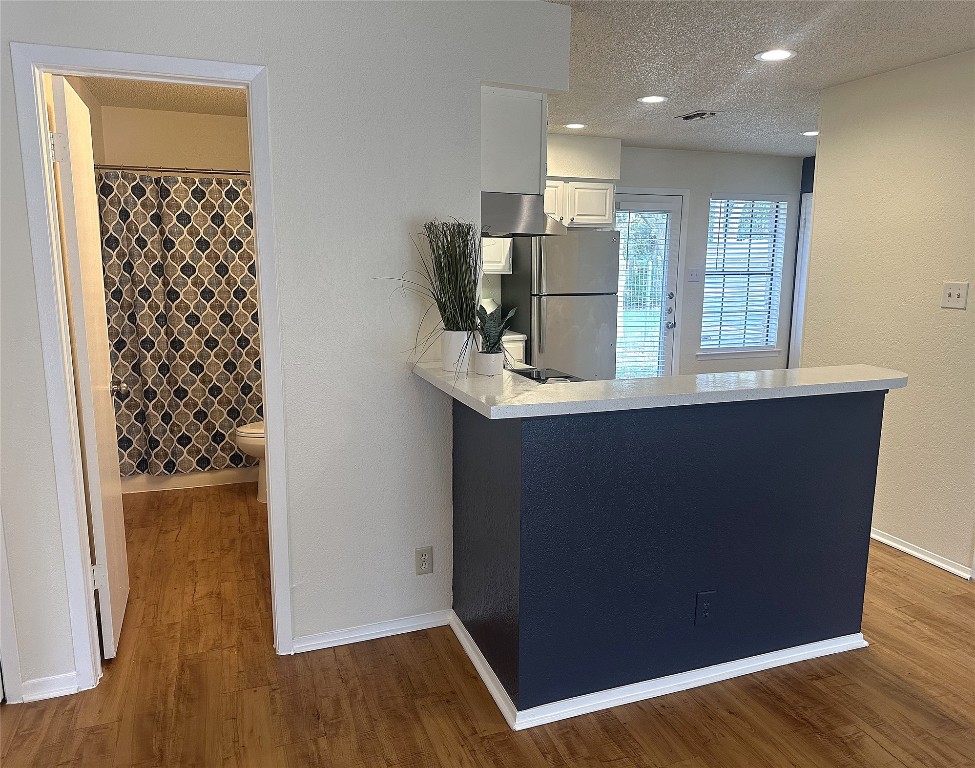 503 Algerita Drive, Unit B Georgetown, TX 78628 - Photo 11 of 30 wooden floor in an empty room with a window