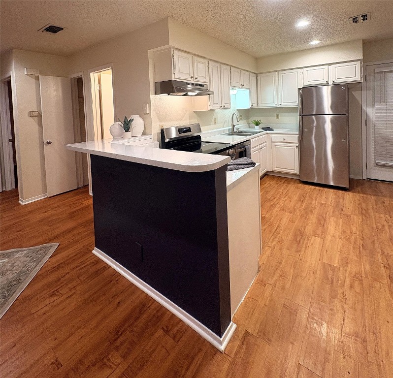 503 Algerita Drive, Unit B Georgetown, TX 78628 - Photo 12 of 30 a kitchen with stainless steel appliances a refrigerator sink and cabinets