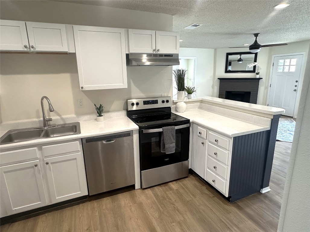 503 Algerita Drive, Unit B Georgetown, TX 78628 - Photo 14 of 30 a kitchen with stainless steel appliances granite countertop a stove a sink and a microwave