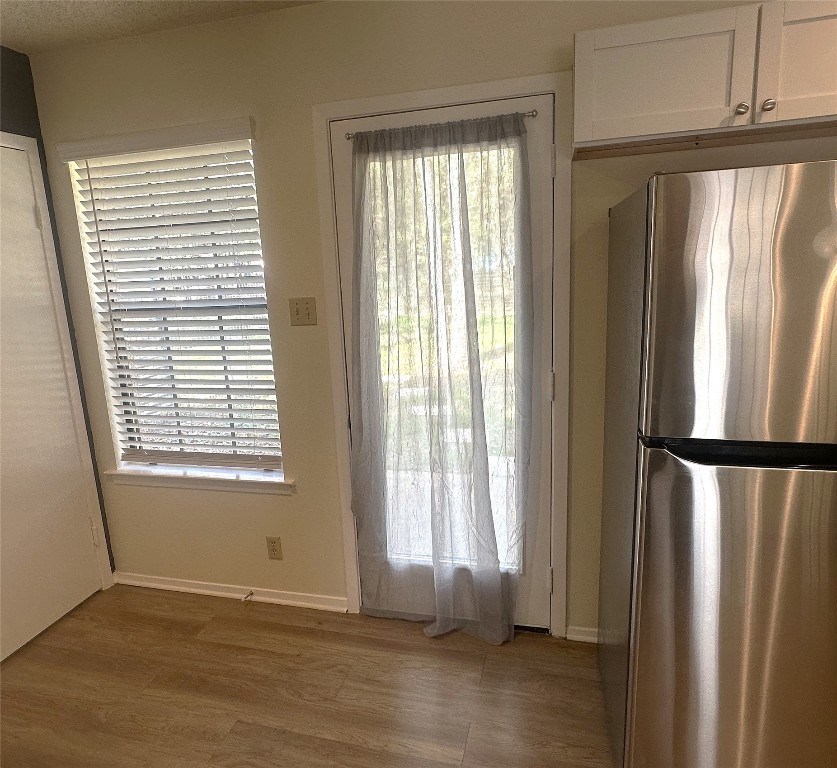 503 Algerita Drive, Unit B Georgetown, TX 78628 - Photo 15 of 30 a view of an empty room with wooden floor and a window