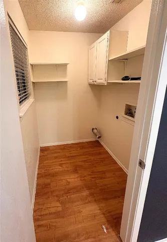 a view of a kitchen with white cabinets