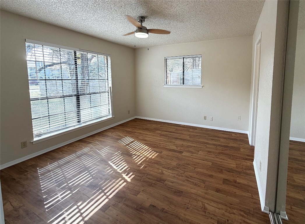 503 Algerita Drive, Unit B Georgetown, TX 78628 - Photo 22 of 30 a view of an empty room with wooden floor and a window