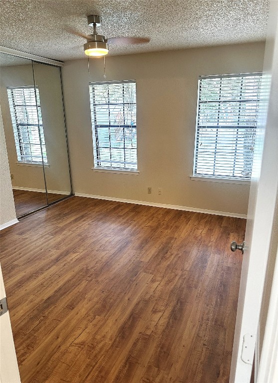503 Algerita Drive, Unit B Georgetown, TX 78628 - Photo 23 of 30 an empty room with wooden floor and windows