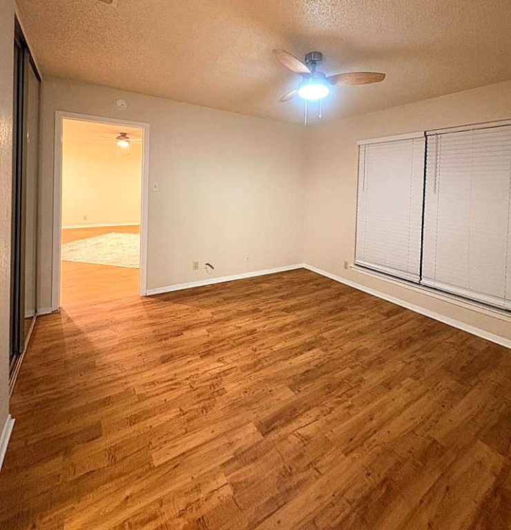 503 Algerita Drive, Unit B Georgetown, TX 78628 - Photo 25 of 30 an empty room with wooden floor and a window