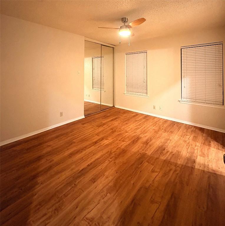 503 Algerita Drive, Unit B Georgetown, TX 78628 - Photo 26 of 30 an empty room with wooden floor and windows
